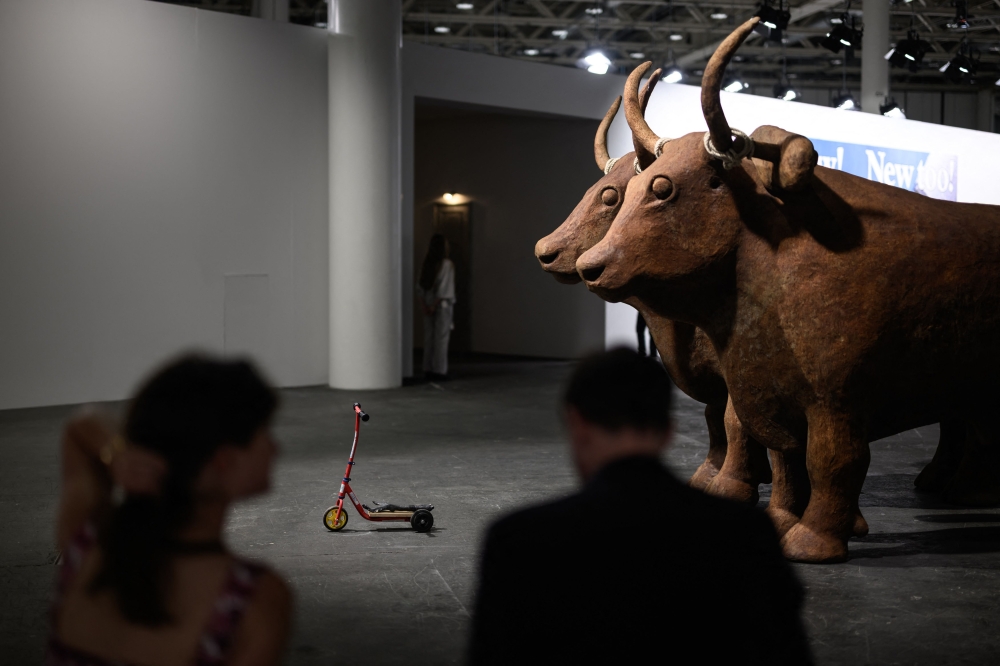 Visitors look at the artwork entitled ‘The Voyage — A March to Utopia, 2022’ by Dutch Atelier Van Lieshouton on display at the Unlimited section of the Art Basel modern and contemporary art fair in Basel June 17, 2025. — AFP pic 