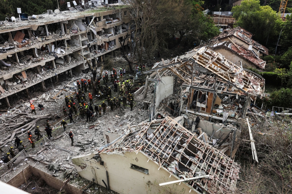 Emergency personnel work at an impact site following a missile attack from Iran on Israel, amid the Iran-Israel conflict, in Tel Aviv, Israel, June 22, 2025. — Reuters pic