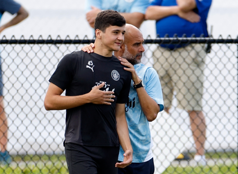 Manchester City’s Abdukodir Khusanov and manager Pep Guardiola are seen during a training session at Lynn University in Boca Raton, Florida, June 21, 2025, ahead of their Fifa Club World Cup fixture. — Reuters pic