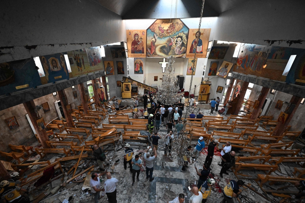 People and rescuers inspect the damage at the site of a reported suicide attack at the Saint Elias church in Damascus’ Dwelaa area on June 22, 2025. Syrian state media reported a suicide attack on a Damascus church on June 22 that caused casualties, as AFP correspondents at the scene saw first responders transporting people from the site. — AFP pic 