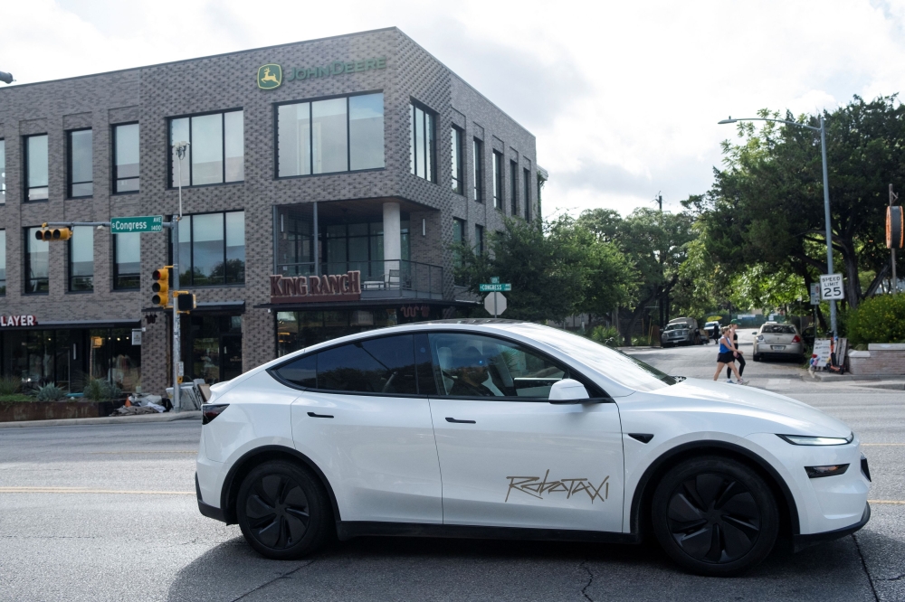 A Tesla robotaxi drives on the street along South Congress Avenue in Austin, Texas June 22, 2025. — Reuters pic