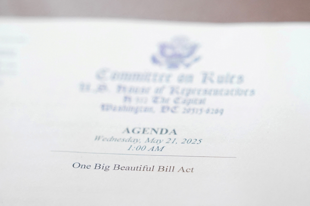 A view of an agenda with the words ‘One Big Beautiful Bill Act’ printed on it, on the day of a House Rules Committee’s hearing on US President Donald Trump’s plan for extensive tax cuts, on Capitol Hill, in Washington, D.C. May 21, 2025. — Reuters pic