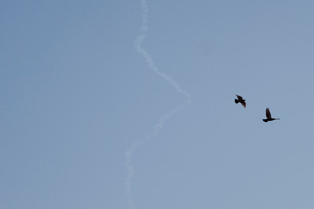 Birds fly as a missile launched from Iran towards Israel is seen from Tubas, amid the Iran-Israel conflict, in the Israeli-occupied West Bank, June 24, 2025. — Reuters pic