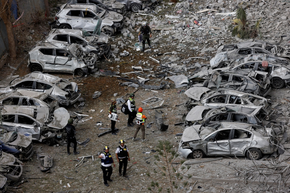 Emergency personnel work amid debris at an impacted residential site, following a missile attack from Iran on Israel, amid the Israel-Iran conflict, in Be’er Sheva, Israel June 24, 2025. — Reuters pic 