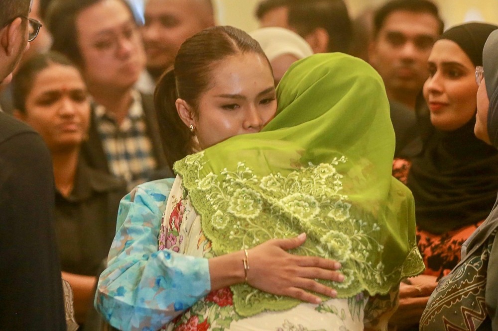 Sharifah Mahani Syed Abdul Aziz, mother of Syed Saddiq Syed Abdul Rahman, embraces actress Bella Astillah as they leave the courtroom following the Muar MP’s acquittal of four corruption and money laundering charges at the Palace of Justice, Putrajaya. — Picture by Sayuti Zainudin