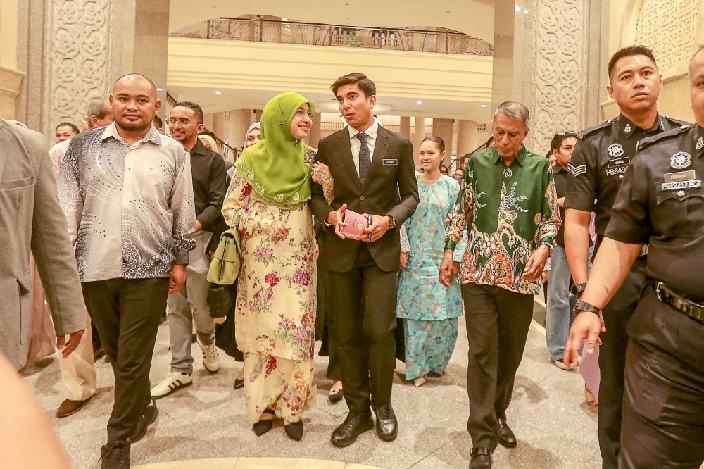 Muar MP Syed Saddiq Syed Abdul Rahman walks out of the courtroom, accompanied by his family and supporters, after being acquitted of four corruption and money laundering charges at the Palace of Justice, Putrajaya today. — Picture by Sayuti Zainudin
