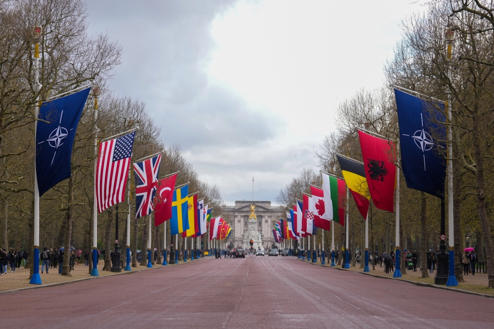 Flags of Nato and its member states are displayed along The Mall, in front of Buckingham Palace in London April 3, 2024. Britain will reintroduce fighter jets capable of carrying atomic weapons to support Nato’s nuclear mission, expanding the country’s deterrence arsenal, which is currently limited to submarine-launched missiles, Prime Minister Keir Starmer’s office said yesterday. — Reuters pic