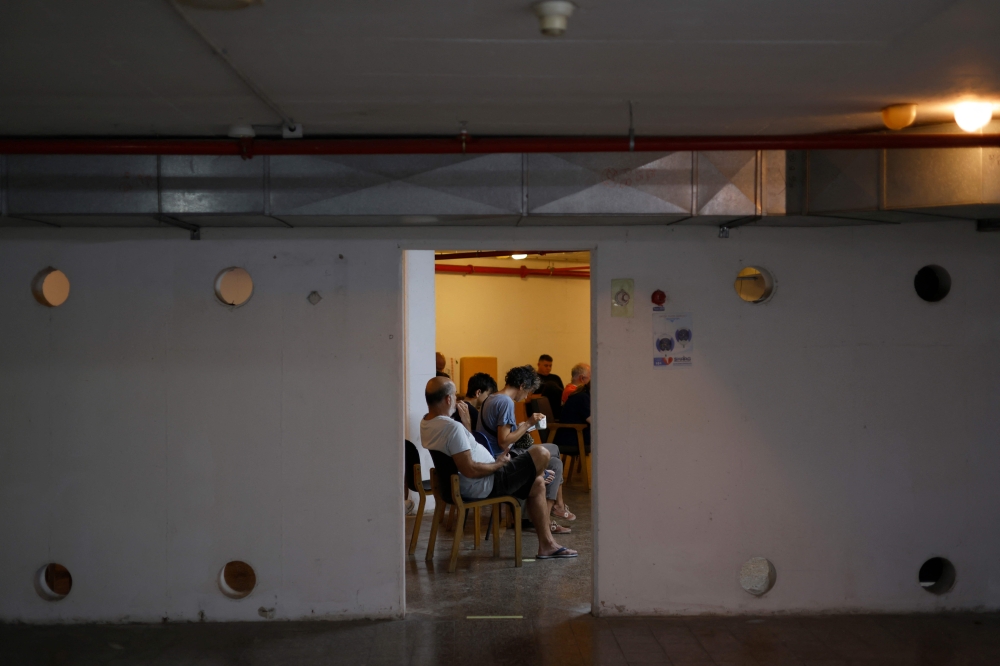 People sit in a shelter after air raid sirens sounded warning of a fresh barrage of Iranian rockets in the Israeli city of Haifa on June 24, 2025. Taiwan will issue new air-raid guidance for its citizens next week, according to security officials and internal planning documents reviewed by Reuters, learning lessons from Ukraine and Israel in case it needs to counter a Chinese military attack. — AFP pic 