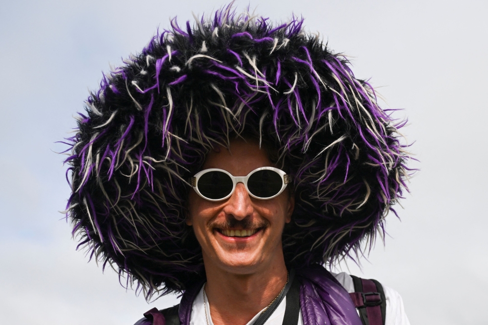 A reveller reacts as they attend the Glastonbury Festival at Worthy Farm in Pilton, Somerset June 25, 2025. — Reuters pic  