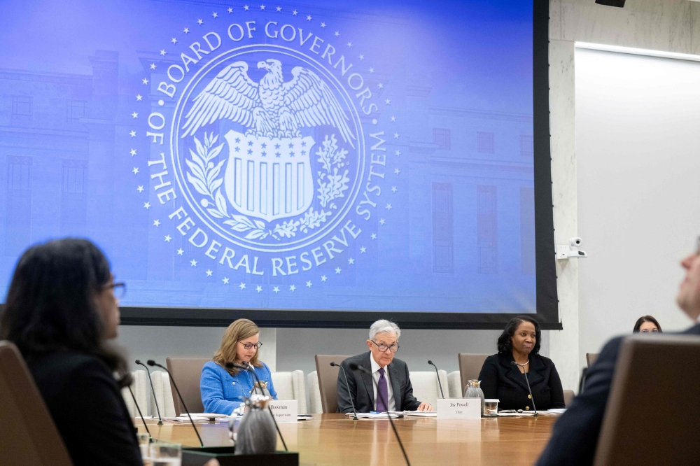 Chairman of the US Federal Reserve Jerome Powell speaks alongside Michelle Bowman (left), Board Vice Chair for Supervision, and Lisa Cook (right), Board Governor, as he chairs a Federal Reserve Board open meeting discussing proposed revisions to the board’s supplementary leverage ratio standards at the Federal Reserve Board building in Washington, DC June 25, 2025. — AFP pic