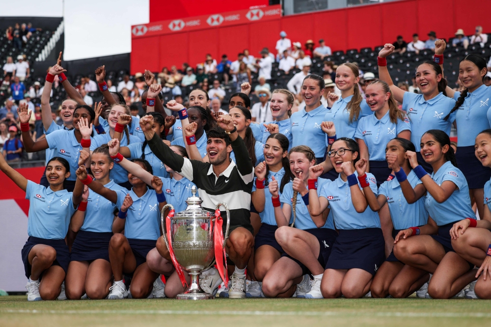 Spain's Carlos Alcaraz poses with ballgirls as he celebrates with the trophy after winning against Czech Republic's Jiri Lehecka in their men's singles final tennis match at the HSBC ATP tennis Championships at Queen's Club in west London on June 22, 2025. — AFP pic