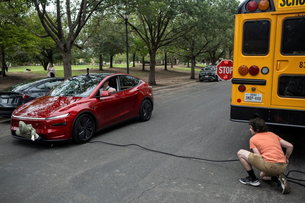 Arthur Maltin, a test driver with The Dawn Project, hits a crash dummy as it crosses the road during a safety test on a Tesla Model Y’s self-driving feature at a protest against Tesla robotaxis, ahead of the Tesla robotaxis’ official services in Austin, Texas, June 12, 2025. — Reuters pic