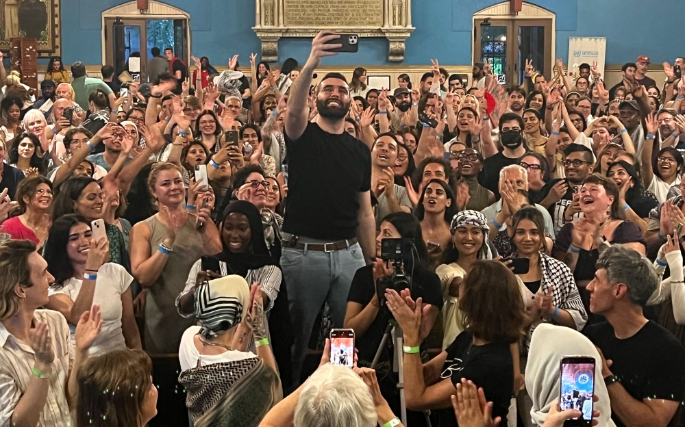 Palestinian photographer and Instagram star Motaz Azaiza in the middle of the crowd during an event at the First Unitarian Church of Philadelphia to collect donations for UNRWA, in Philadelphia, Pennsylvania, on June 23, 2025. — AFP pic 