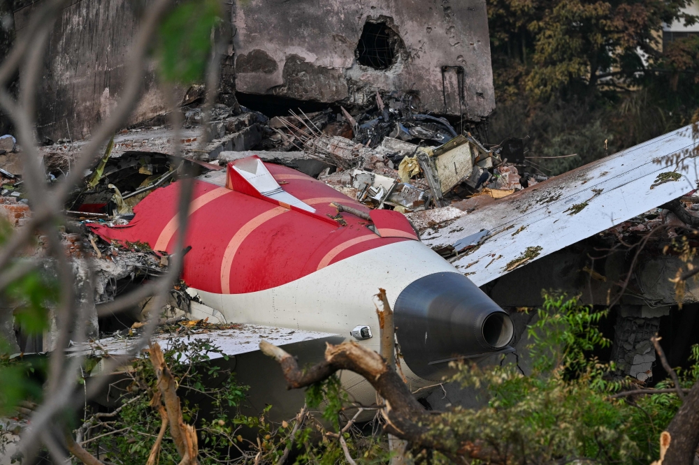 Wreckage showing the tail section of the Air India Boeing 787-8 is pictured in a residential area near the airport in Ahmedabad June 14, 2025. — AFP pic