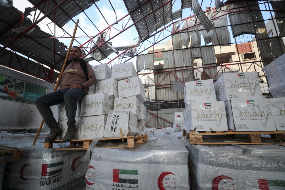 A Palestinian worker sits on aid inside a warehouse, in Gaza City, June 25, 2025. — Reuters pic 