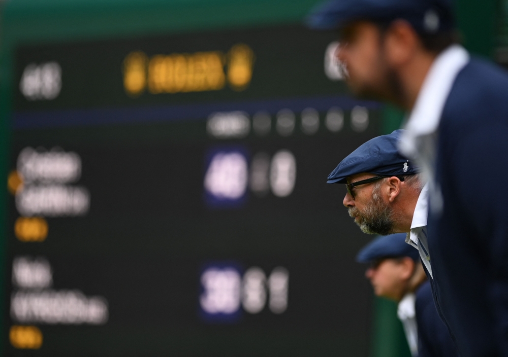 Line judges stare the court during the men’s singles quarter-final match on the 10th day of the 2022 Wimbledon Championships at The All England Tennis Club in Wimbledon July 6, 2022. — AFP pic