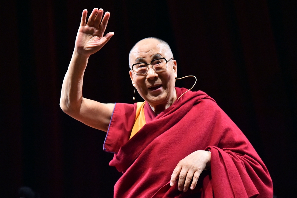 Tibetan spiritual leader the Dalai Lama gestures during a ceremony wherein he was made an honorary citizen of Milan, in Milan October 20, 2016. The charismatic Buddhist spiritual leader lauded worldwide for his tireless campaign for greater autonomy for his Tibetan homeland, will celebrate his 90th birthday on July 6. — AFP pic