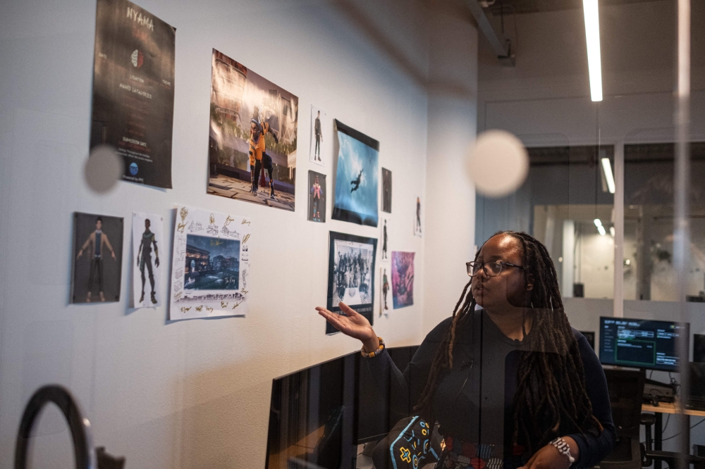 Sithe Ncube, producer at Nyamakop video game studio, points to a character’s design for a soon-to-be-launched video game called ‘Relooted’ at their office space in Rosebank, near Johannesburg, June 20, 2025. — AFP pic