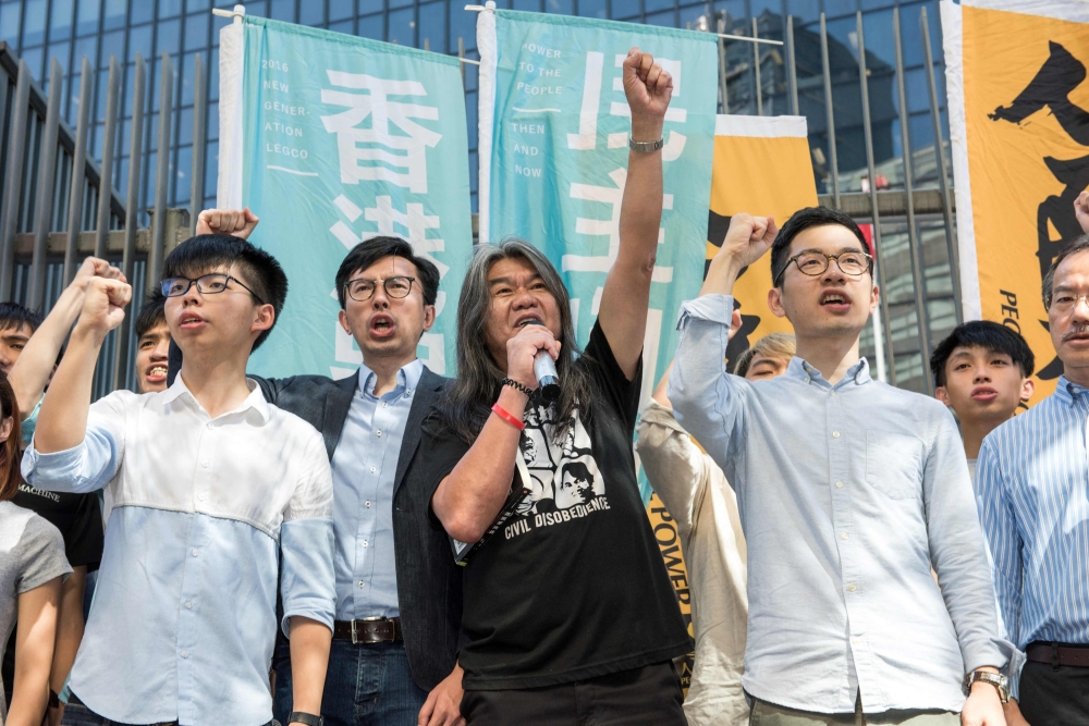 (Left to right) Student protest leader Joshua Wong, Hong Kong pro-democracy party League of Social Democrats (LSD) chairman Avery Ng, pro-democracy lawmaker Leung Kwok-hung, also known as ‘Long Hair’, and pro-democracy lawmaker Nathan Law hold a protest against their recent arrests and detention ahead of the visit by China’s President Xi Jinping, outside Civic Square at the Central Government Offices in Hong Kong June 30, 2017. — AFP pic