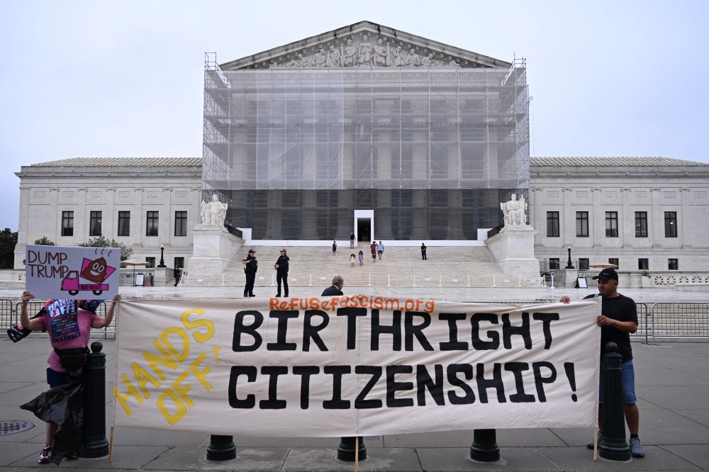 Demonstrators holds up an anti-Trump sign outside the US Supreme Court in Washington, DC, on June 27, 2025. — AFP pic