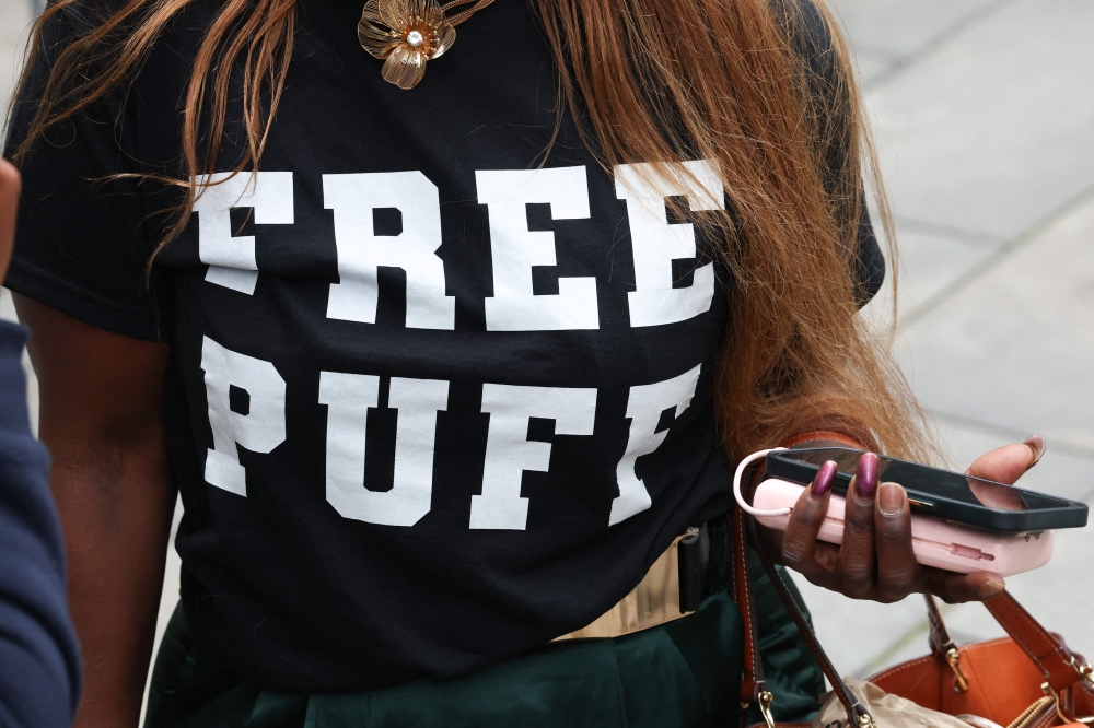 A woman wears a shirt reading ‘Free Puff’ in support of Sean ‘Diddy’ Combs outside of federal court in Manhattan during Sean ‘Diddy; Combs' sex trafficking trial on June 27, 2025, in New York City. — AFP pic