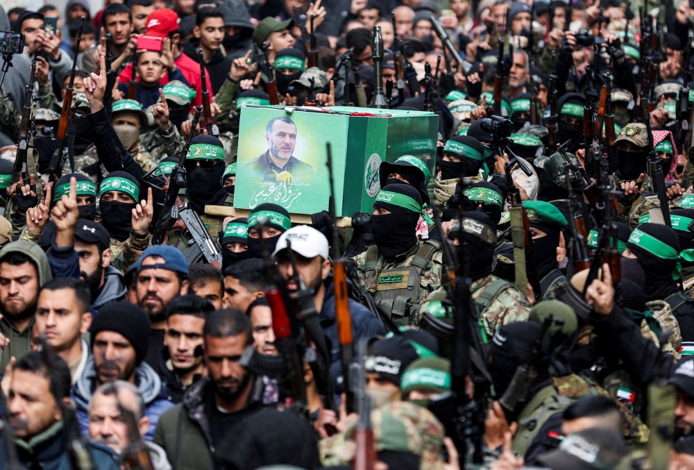 Hamas militants carry the coffin of Marwan Issa, a senior Hamas deputy military commander who was killed in an Israeli airstrike during the conflict between Israel and Hamas, amid a ceasefire between Israel and Hamas, in the central Gaza Strip, February 7, 2025. — Reuters pic  