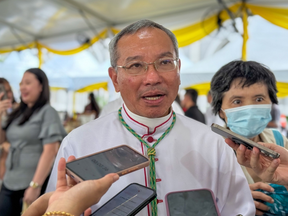 Poh speaks to reporters when met at the event. — The Borneo Post pic