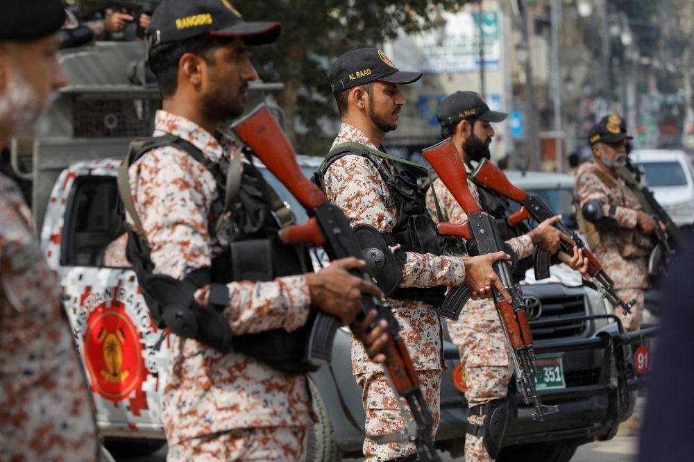 Paramilitary soldiers stand guard along a road, ahead of the general elections in Karachi, Pakistan February 7, 2024. An explosive-laden car rammed into a Pakistani military convoy today in a town near the Afghan border, killing at least 13 soldiers, sources said. — Reuters pic