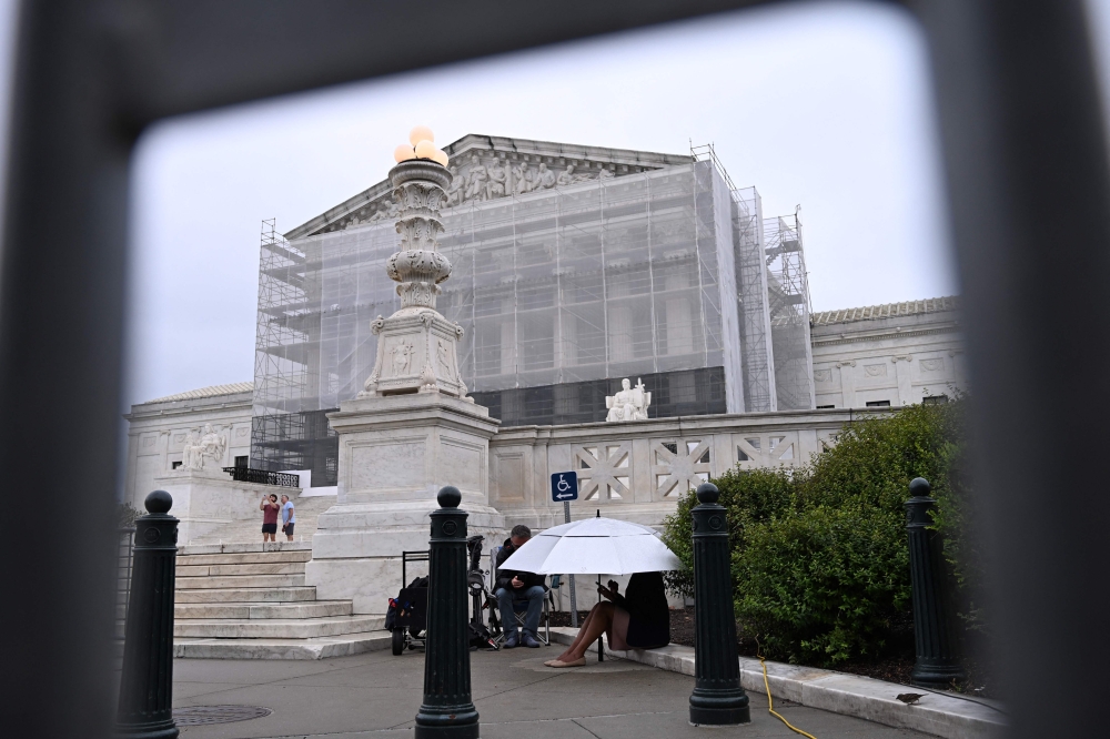 Journalists sit outside the US Supreme Court in Washington, DC, on June 27, 2025. The Supreme Court is to issue its final rulings yesterday ahead of its summer break, including cases involving birthright citenzenship, porn site age verification, students and LGBTQ-themed content, and voting rights. — AFP pic 