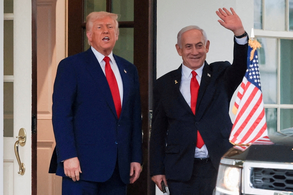 File picture of US President Donald Trump speaking as Israeli Prime Minister Benjamin Netanyahu waves following a meeting in the White House Washington, April 7, 2025. The US leader has likened Netanyahu’s legal troubles to his own before he took office for his second term. — Reuters pic