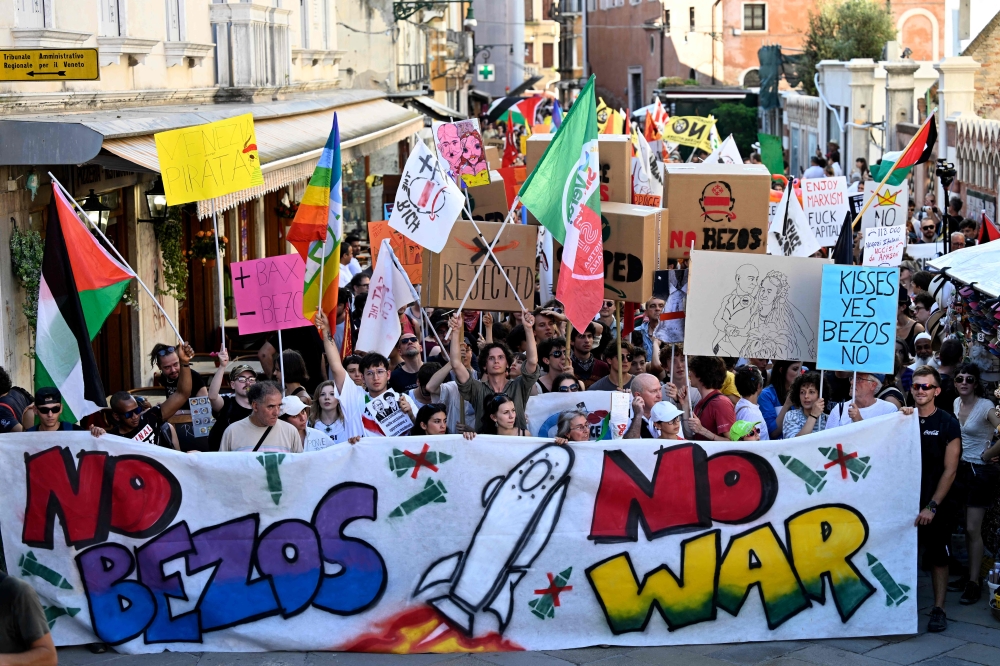 People take part in a protest 'No Space for Bezos' a day after the wedding ceremony of Jeff Bezos and Lauren Sanchez in Venice, at Venice's train station June 28, 2025. — AFP pic 