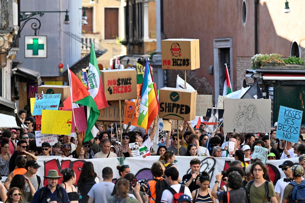 People take part in a protest 'No Space for Bezos' a day after the wedding ceremony of Jeff Bezos and Lauren Sanchez in Venice, at Venice's train station on June 28, 2025. — AFP pic