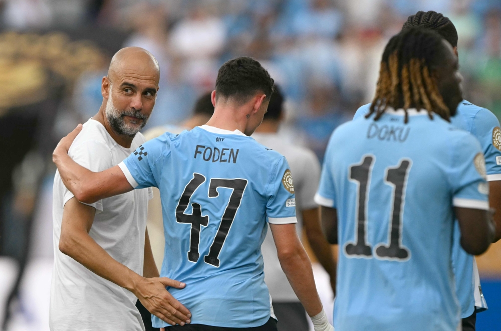 Manchester City coach Pep Guardiola reacts with English midfielder Phil Foden at the end of the Fifa Club World Cup 2025 Group D football match between Italy’s Juventus and England’s Manchester City at the Camping World stadium in Orlando on June 26, 2025. — AFP pic 