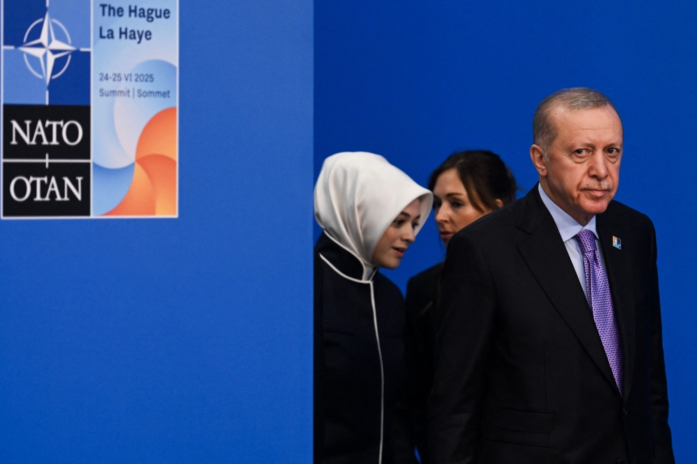 Turkey's President Recep Tayyip Erdogan (right) arrives for the North Atlantic Treaty Organisation (NATO) Heads of State and Government summit in The Hague, on June 25, 2025. NATO leaders hold a two-day summit on June 24 and 25 in The Hague. — AFP pic