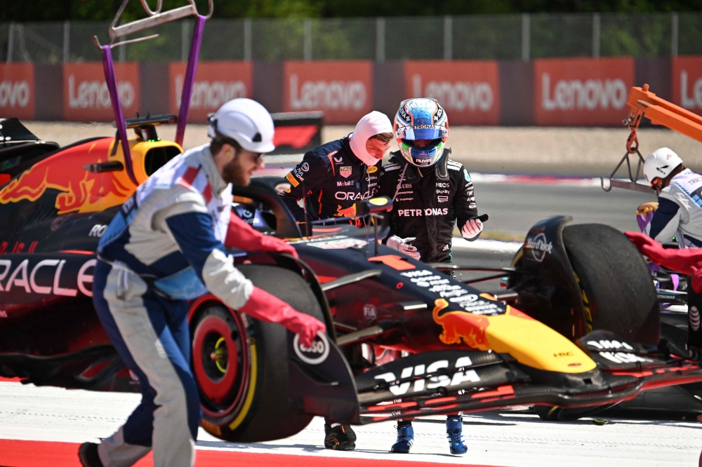 Red Bull's Dutch driver Max Verstappen (back left) and Mercedes' Italian driver Kimi Antonelli speak after their cars crashed during the Formula One Austrian Grand Prix at the Red Bull Ring race track in Spielberg, Austria, on June 29, 2025. — AFP pic