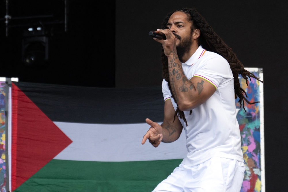 To the backdrop of a Palestinian flag, Bobby Vylan of British duo Bob Vylan performs on the West Holts Stage on the fourth day of the Glastonbury festival at Worthy Farm in the village of Pilton in Somerset, south-west England, on June 28, 2025. — AFP pic 