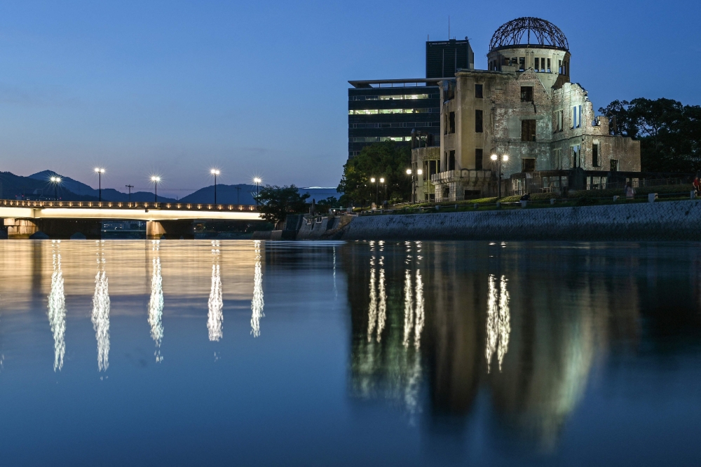 This photo taken on June 26, 2025 shows a general view of the Atomic Bomb Dome (right) at dusk in the centre of Hiroshima, Hiroshima prefecture. This August marks the 80th anniversaries of the atomic bombings of Hiroshima and Nagasaki in 1945, as well as the 80th anniversary of the end of the Pacific theatre of World War II. — AFP pic 