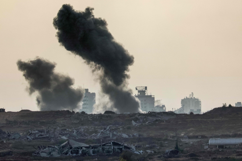 This picture taken from a position at Israel’s border with the Gaza Strip shows smoke billowing during an Israeli strike on the besieged Palestinian territory on July 1, 2025. — AFP pic 