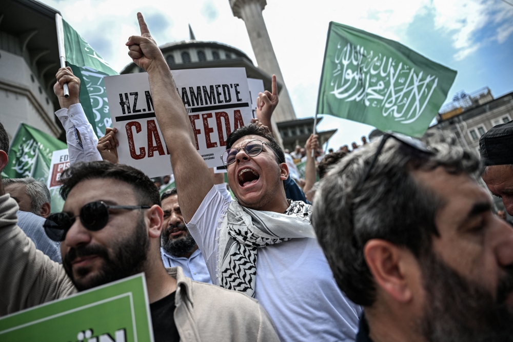 Protesters demonstrate against cartoonists of a satirical magazine following allegations that it had published a cartoon of the Prophet Muhammad, outside Taksim mosque in Istanbul on July 1, 2025. — AFP pic 