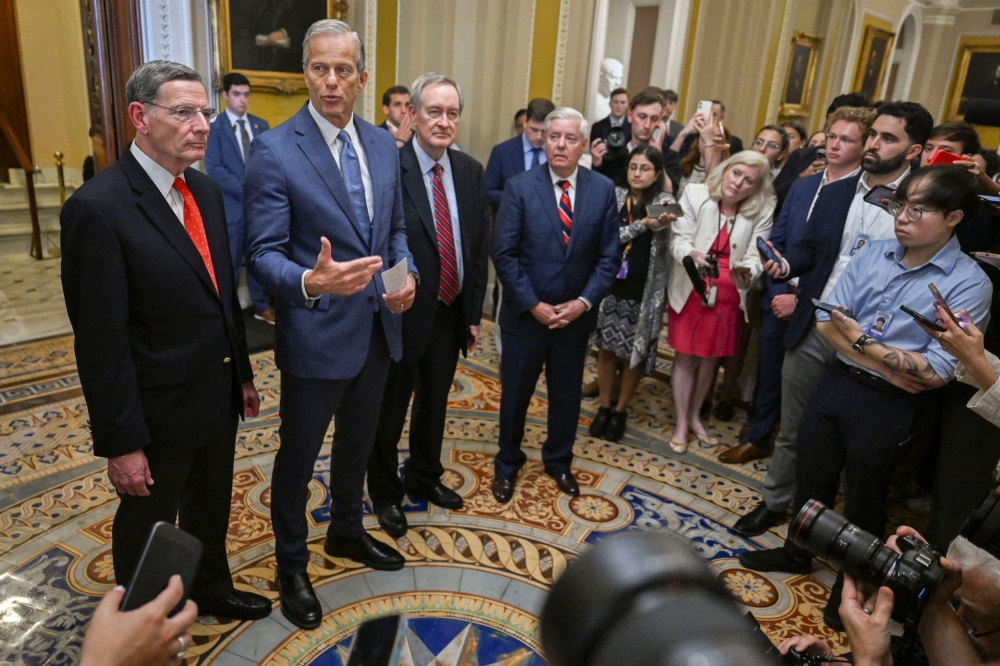 US Senate Majority Leader John Thune (R-SD) speaks to the press next to US Senator John Barrasso (R-WY) and Senator Mike Crapo (R-ID) after the Senate passes US President Donald Trump’s sweeping spending and tax bill, on Capitol Hill in Washington, DC, July 1, 2025. — Reuters pic 