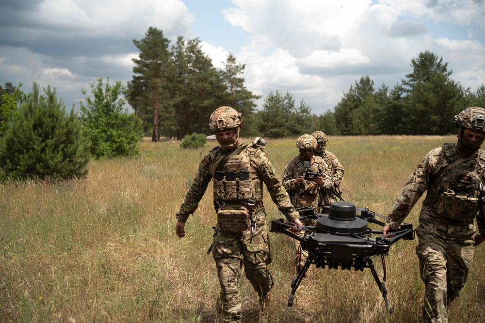  Soldiers from the ‘Black Sky’ battalion of the Spartan brigade carry an agricultural drone, transformed into a front-line delivery cargo, in a field during a demonstration for AFP, at an undisclosed location, not far from the front line, in the region of Dnipropetrovsk, Ukraine, on June 14, 2025. — AFP pic 