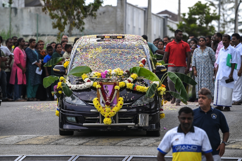 A hearse carrying the body of the Perhentian boat tragedy victim V. Vennpani is seen near Sungai Petani Heights. — Bernama pic
