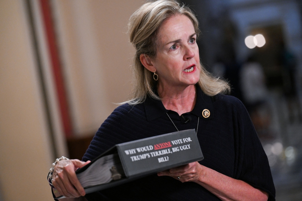 US Representative Madeline Dean (D-PA) holds a binder titled 
