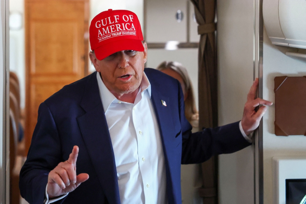 US President Donald Trump speaks to reporters aboard Air Force One en route to Joint Base Andrews, Maryland, July 1, 2025. — Reuters pic