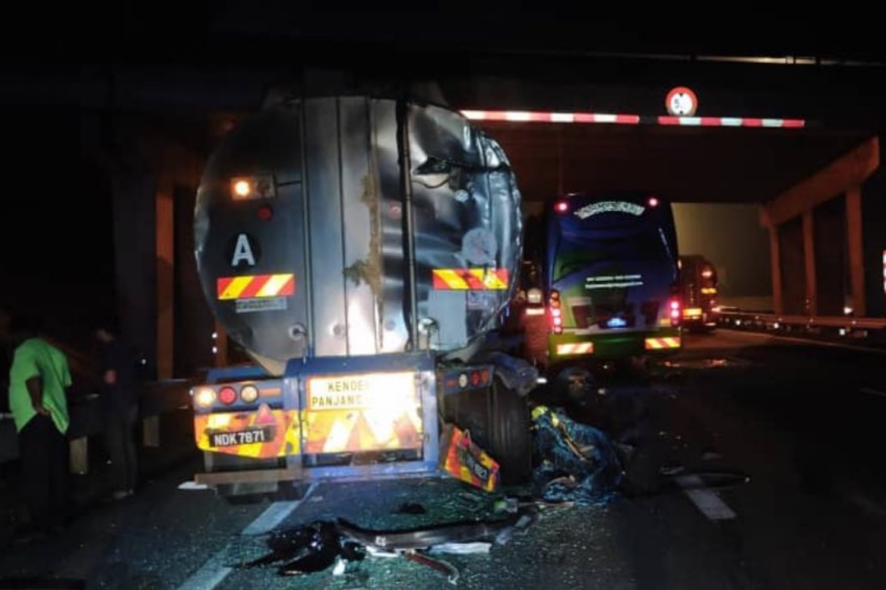 A tour bus and two lorries was involved in a crash near Ayer Hitam at the PLUS highway. — Picture from Facebook