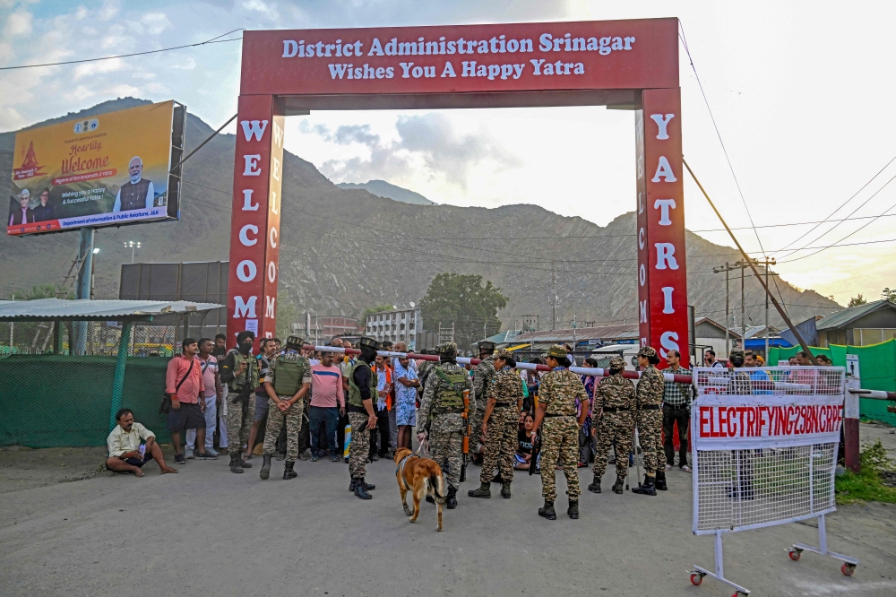 Indian security personnel stand guard as Hindu pilgrims await their registration at a transit camp in Pantha Chowk on the outskirts of Srinagar on July 2, 2025, ahead of the annual Amarnath pilgrimage. — AFP pic