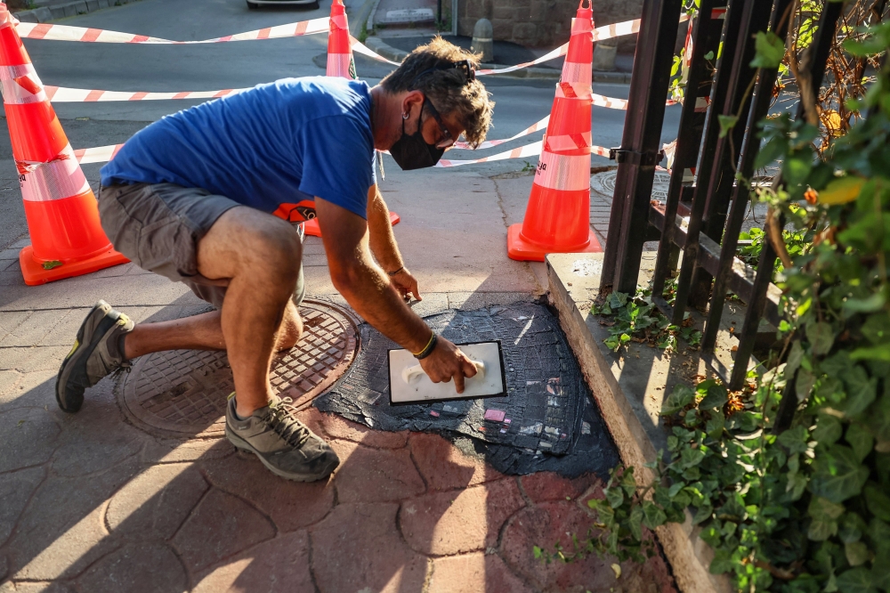 Invited by the French Institute in Ankara, the artist installs what he calls his “flackings,” incorporating geometric motifs in road defects in the Turkish capital Ankara on June 25, 2025. — AFP pic