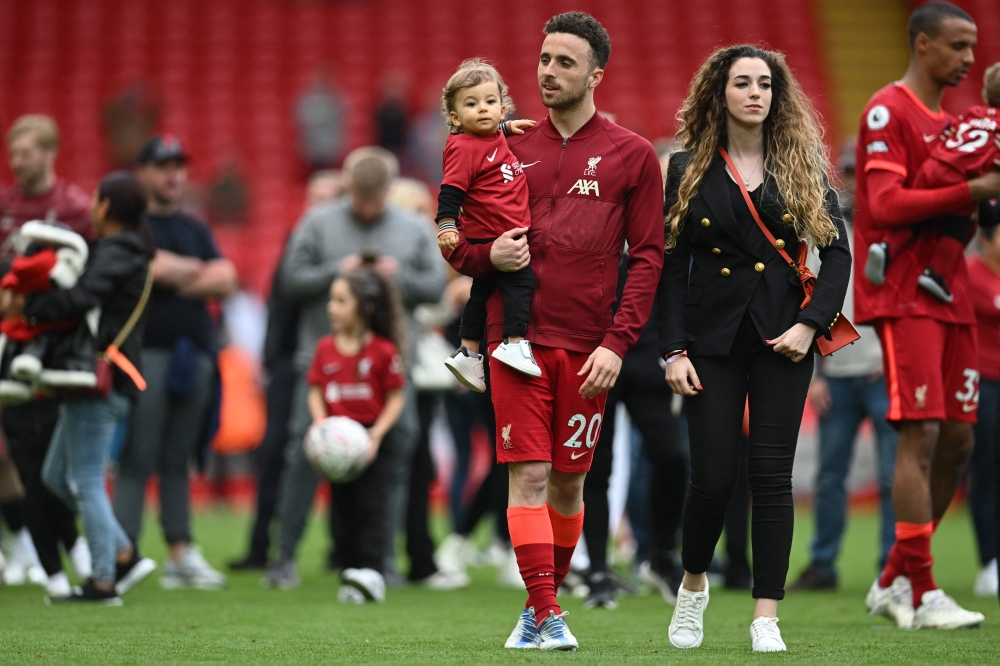This file picture shows Liverpool's Portuguese striker Diogo Jota celebrating with his family during a lap of honour at the end of the English Premier League football match between Liverpool and Wolverhampton Wanderers at Anfield in Liverpool, north west England May 22, 2022. — AFP pic