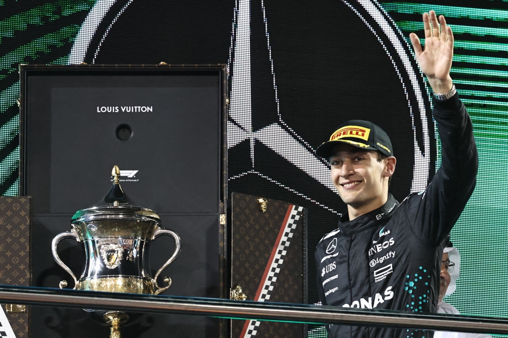 Mercedes' British driver George Russell waves on the podium after the Bahrain Formula One Grand Prix at the Bahrain International Circuit in Sakhir on April 13, 2025. — AFP pic