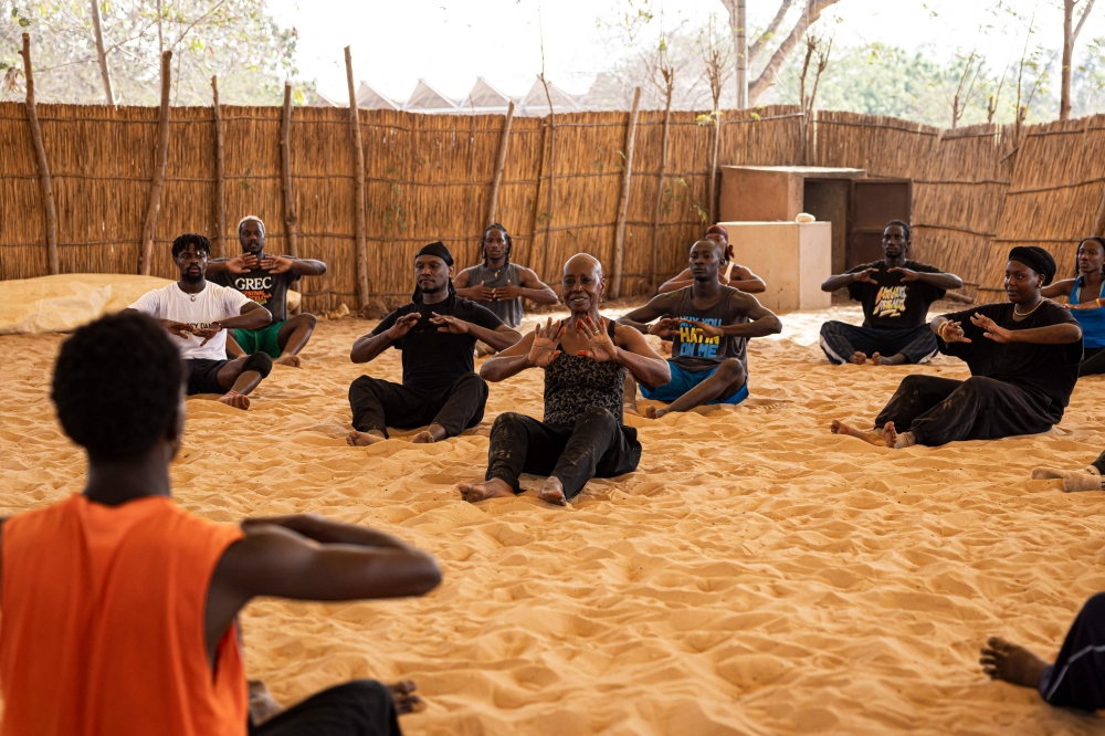 Germaine Acogny (centre) practices with her students during a dancing class at the Ecole des Sables in Toubab Dialaw. — AFP pic